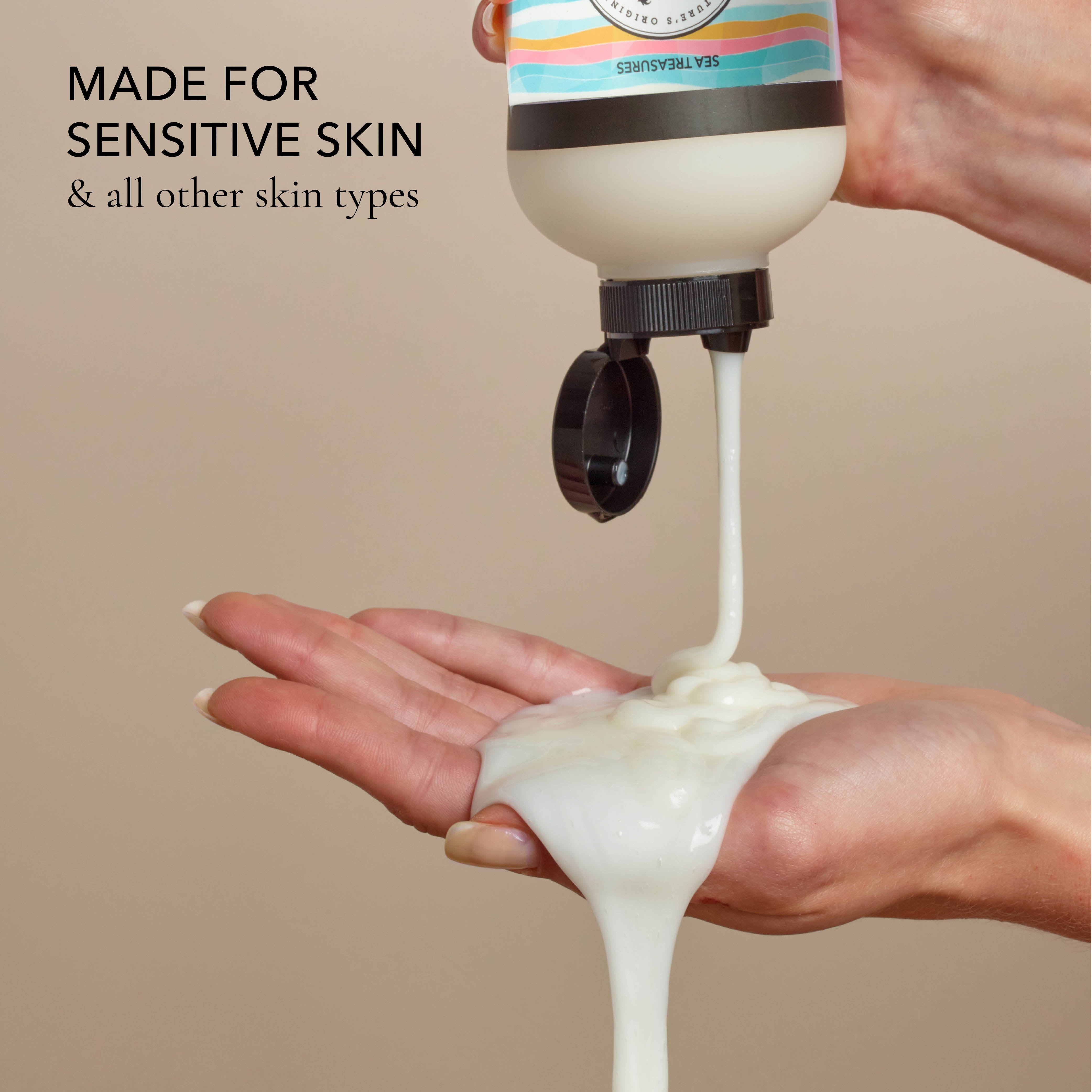 Hand holding a bottle of the shower creme and squeezing it out into the other hand, with the text that says "made for sensitive skin & all other skin types", all on a beige background.