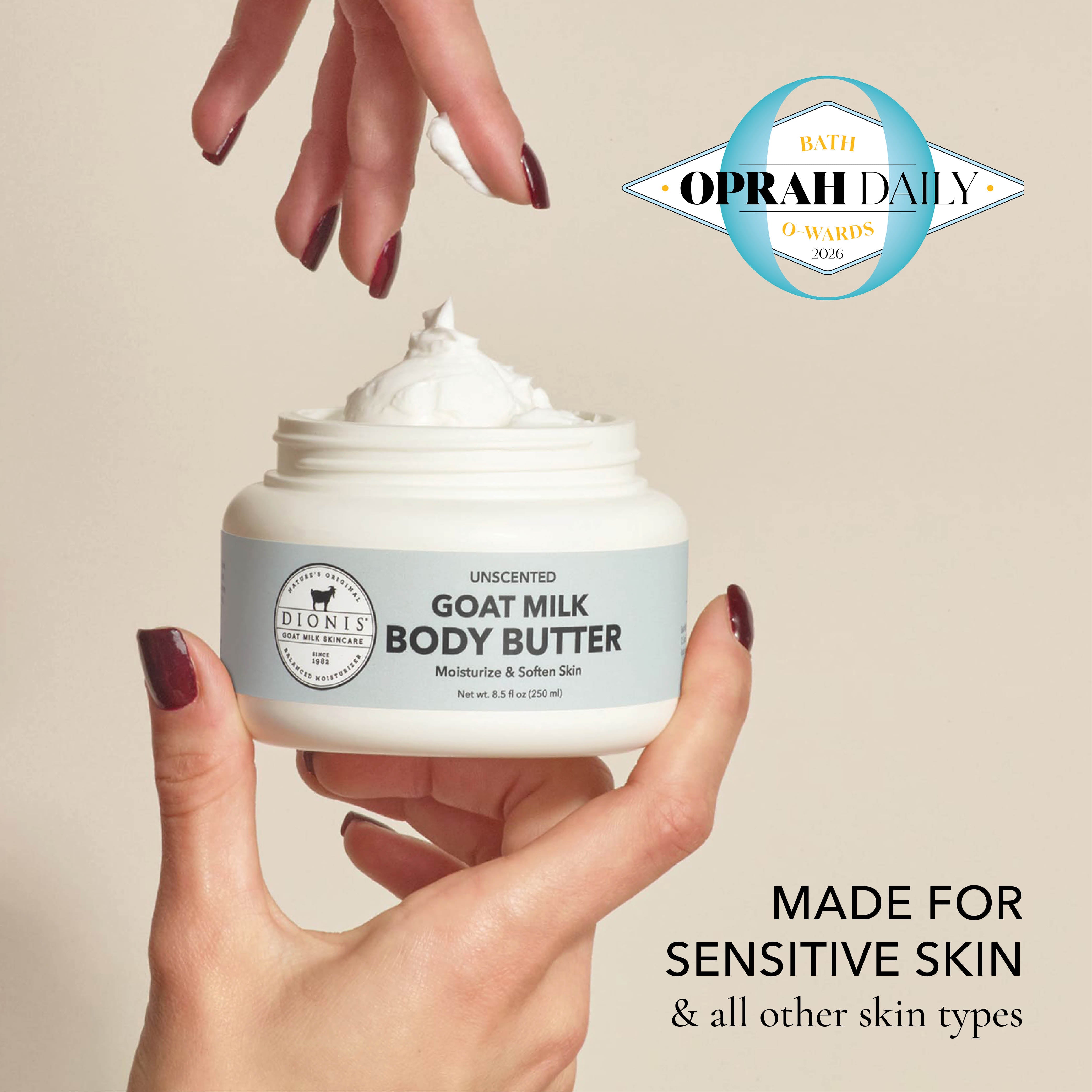 A woman's hand holding an open jar of Dionis Goat Milk Body Butter