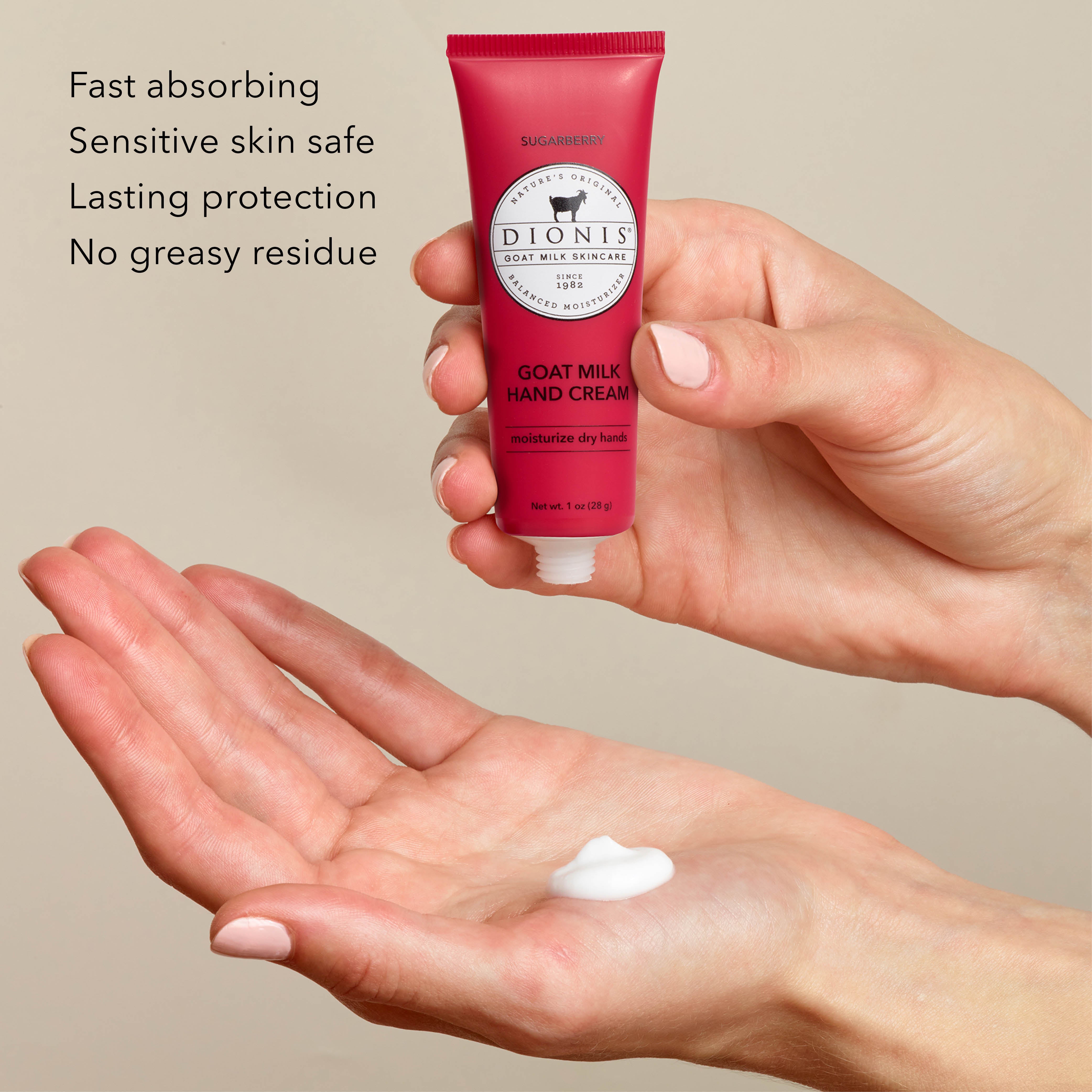 A person holds a red tube of Dionis Goat Milk Hand Cream, Sugarberry, above their open palm, with a dollop of white cream resting in the palm below. Text on the left lists product benefits: 'Fast absorbing, Sensitive skin safe, Lasting protection, No greasy residue'.
