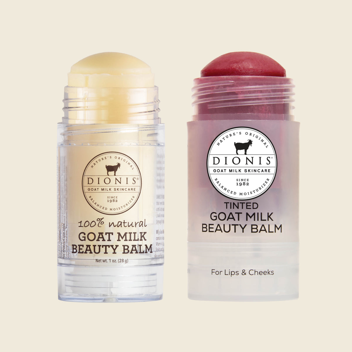 Two Dionis Goat Milk Beauty Balm tubes on a light beige background. The left tube is open, showing a pale yellow balm stick, while the right tube is tinted pinkish-purple with a dark red balm stick visible at the top.