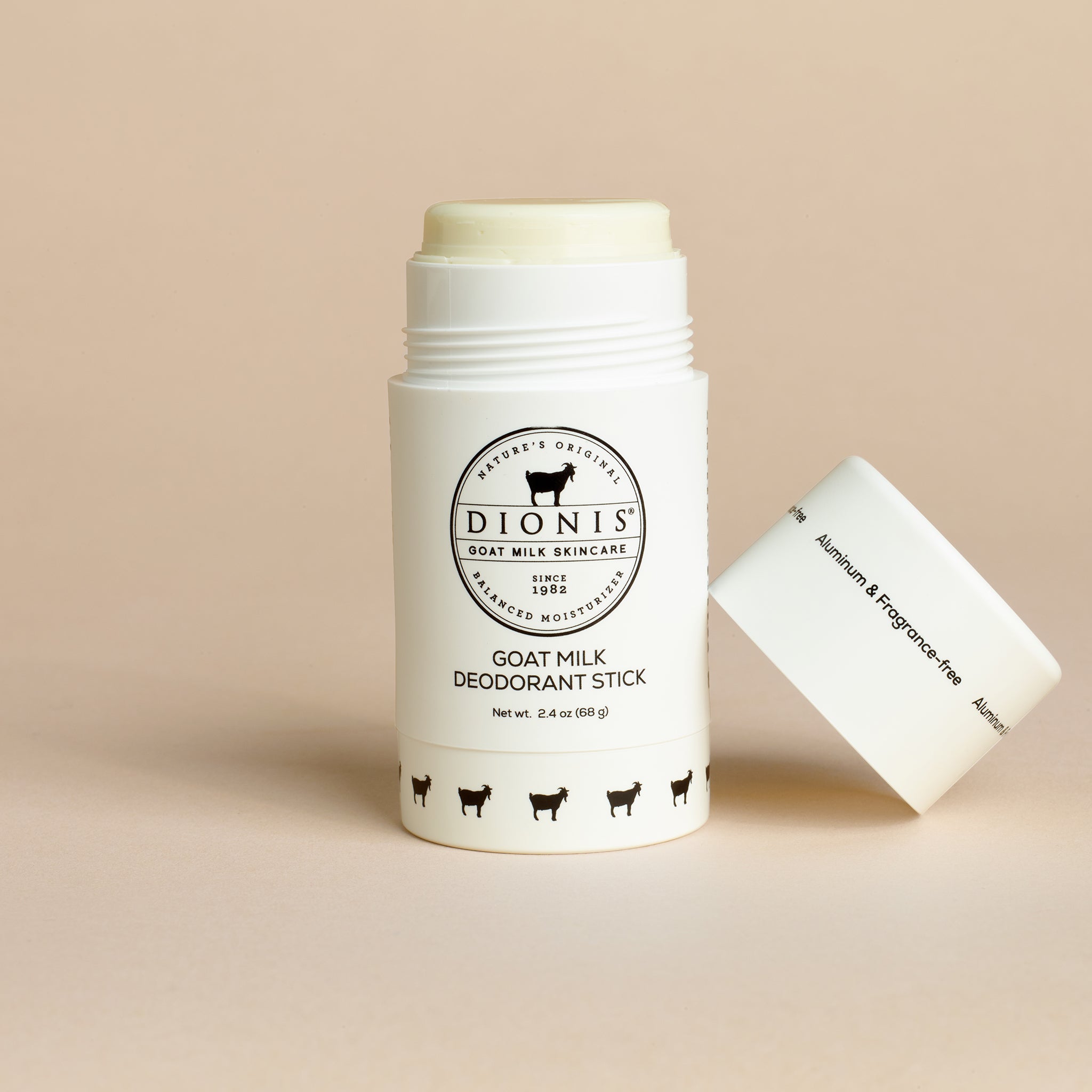 Dionis Goat Milk Deodorant Stick with cap removed on beige background