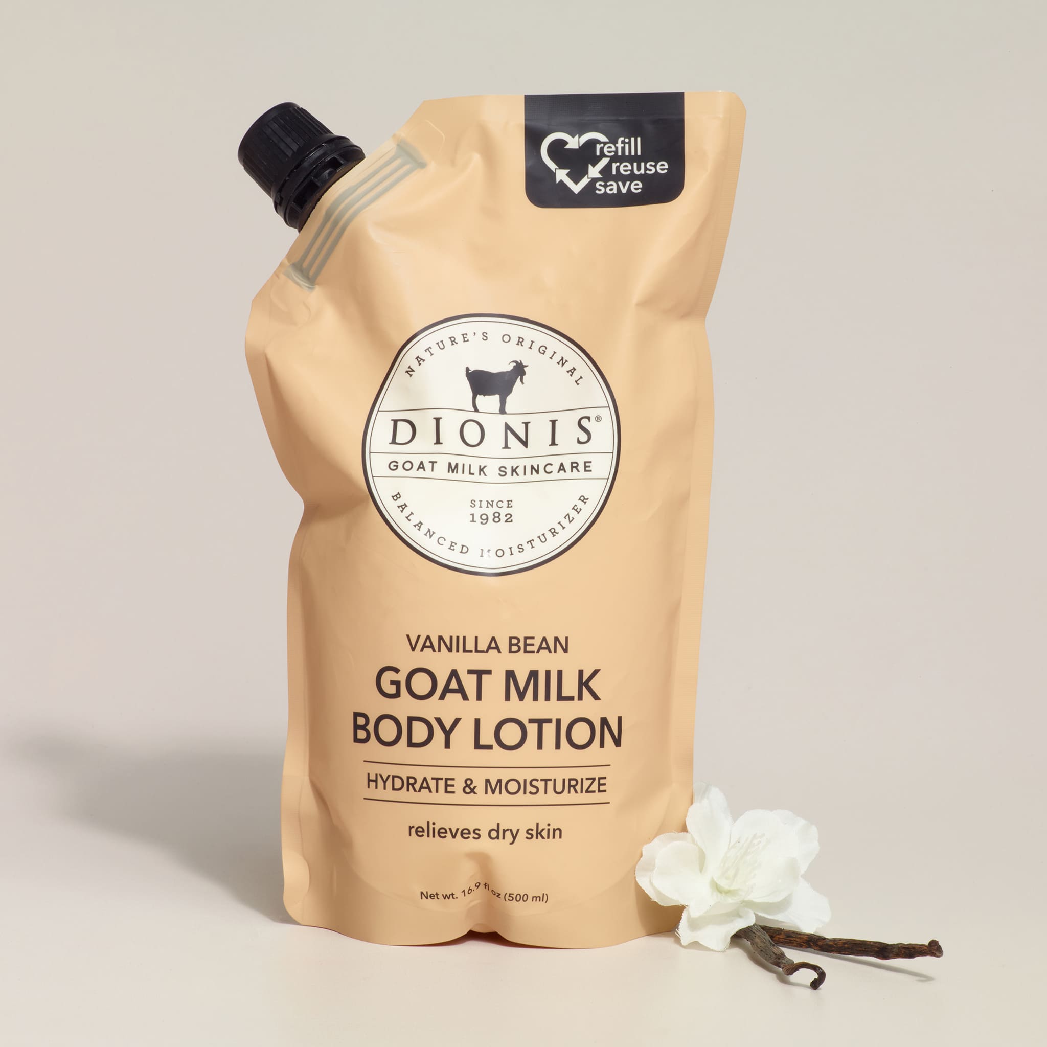 Dionis goat milk body lotion packaging with vanilla bean and flower on a light background