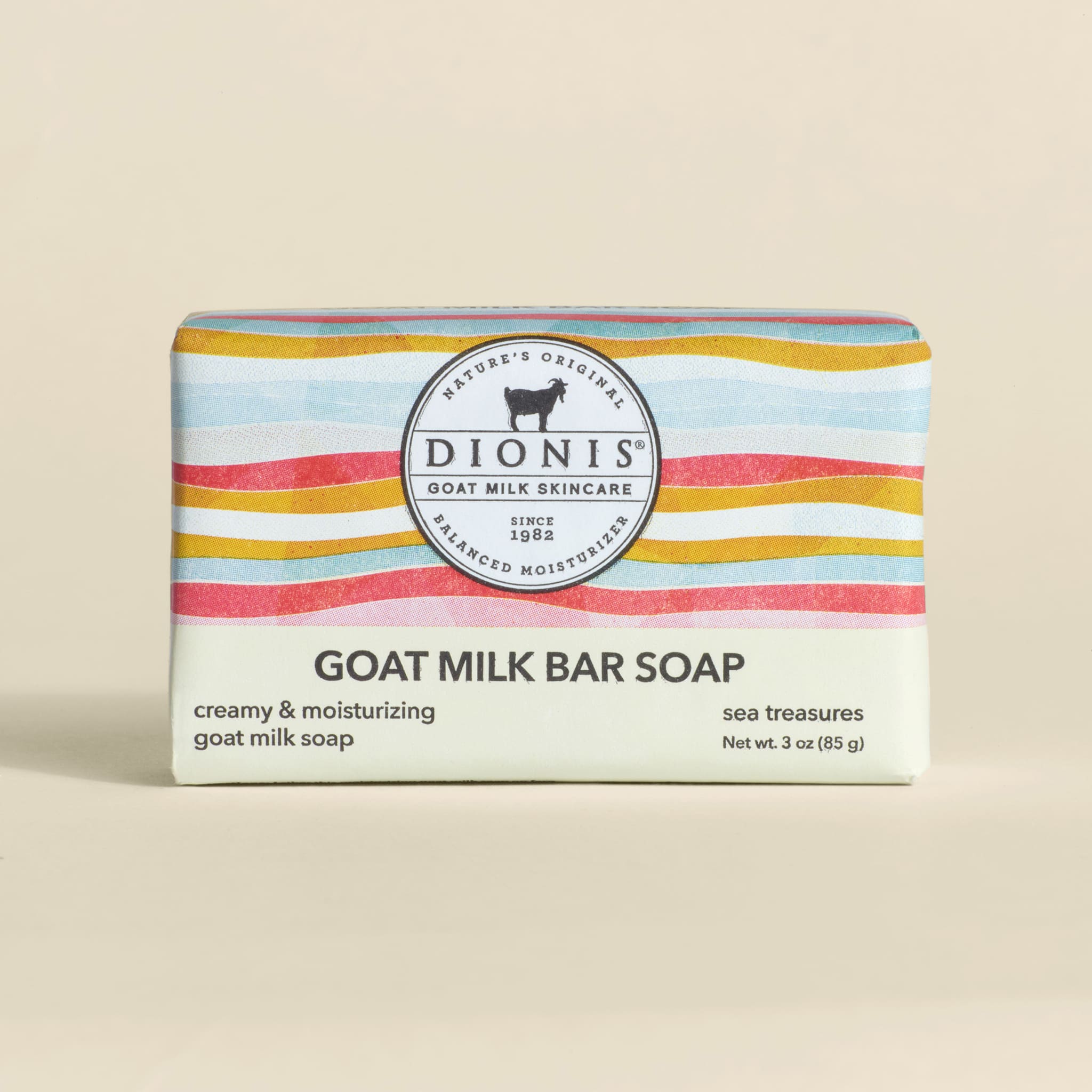 Dionis goat milk bar soap with colorful packaging on a beige background
