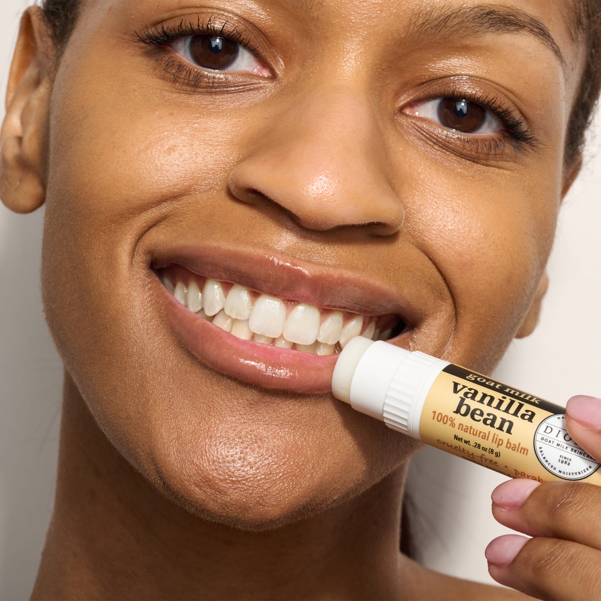woman applying vanilla bean lip balm