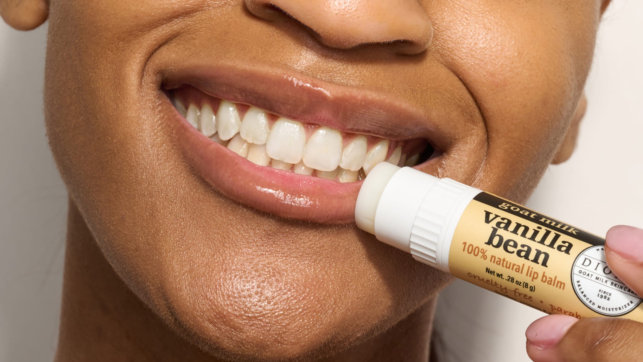 woman applying vanilla bean lip balm