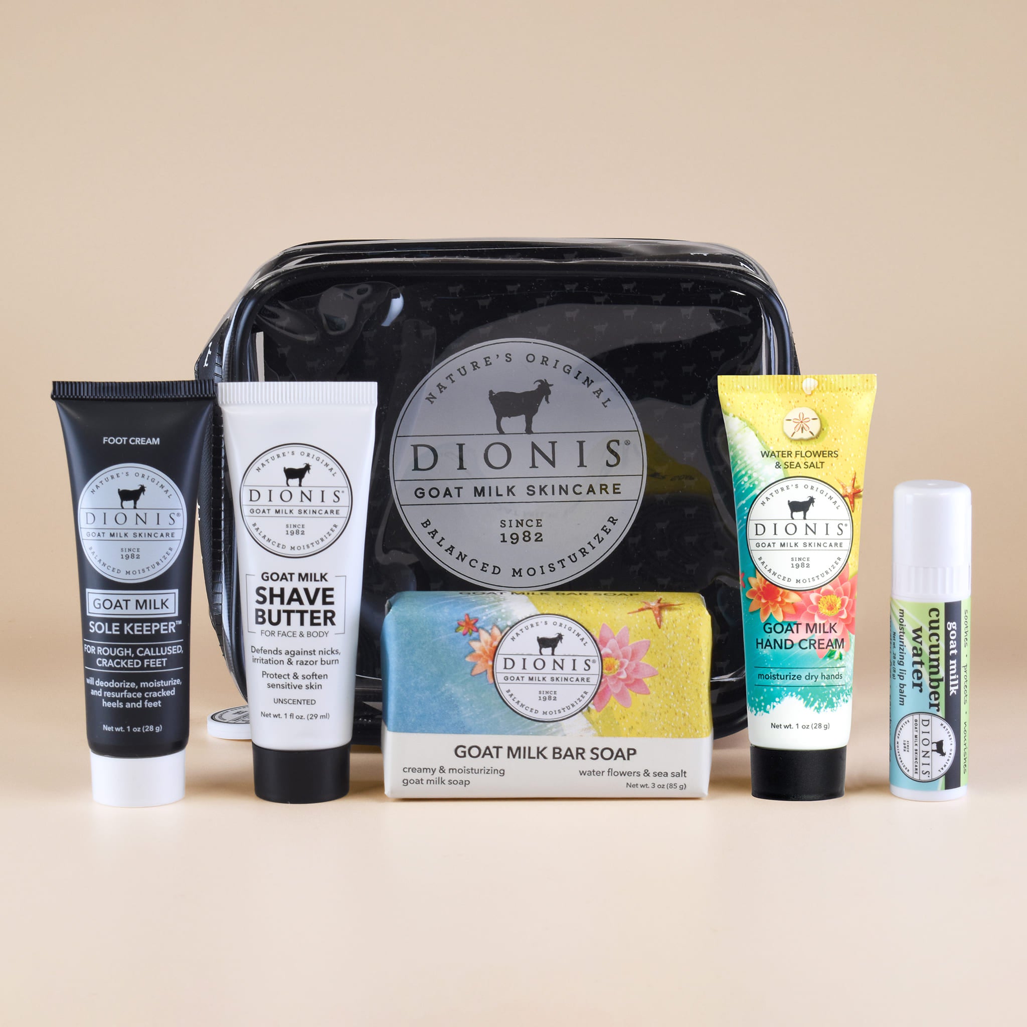 The items included in the Water Flowers & Sea Salt Travel Kit displayed in front of the clear toiletry bag.