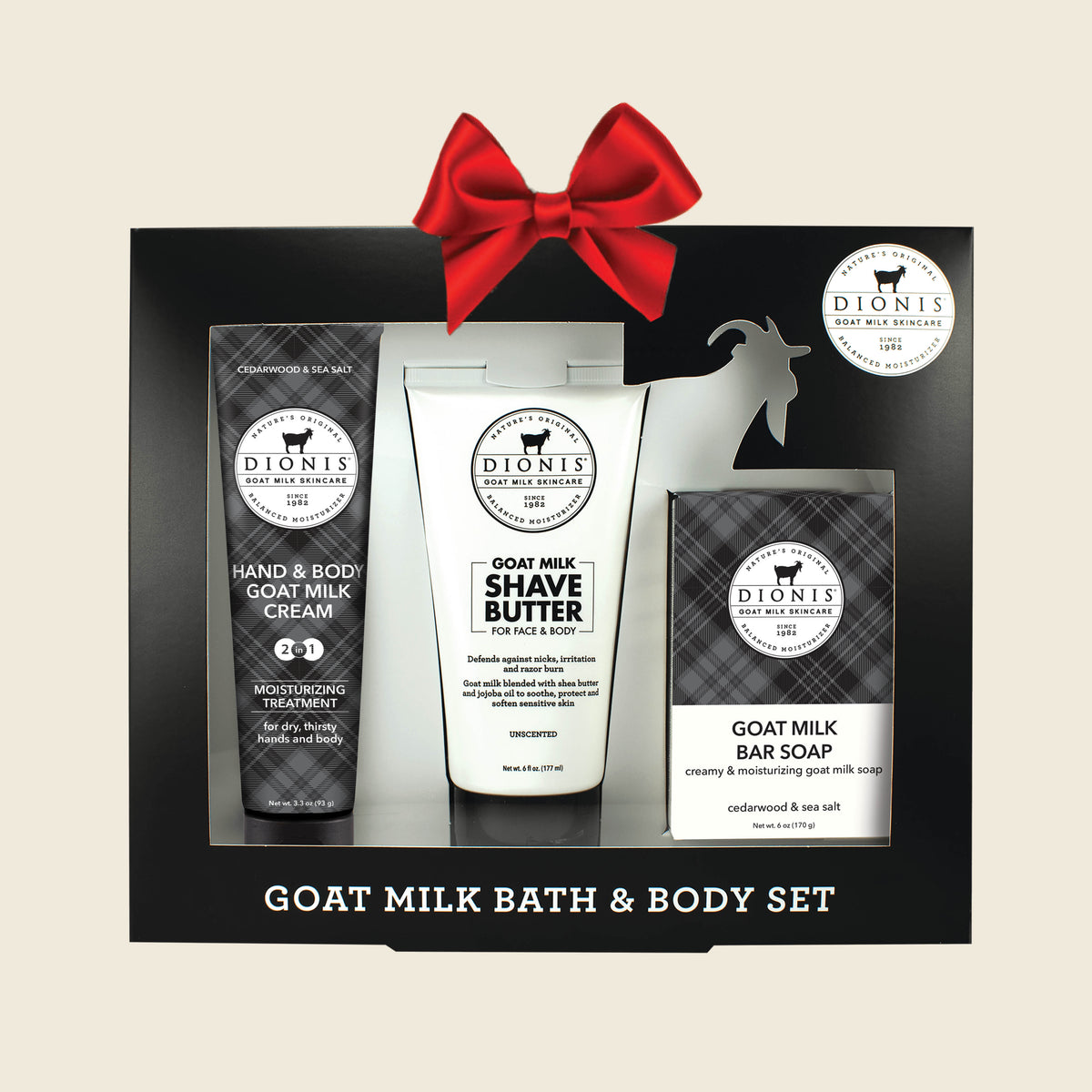 Dion's Goat Milk Bath & Body Set in a black gift box with three products visible: a hand & body goat milk cream tube, a shave butter tube, and a bar soap box, on a light beige background.