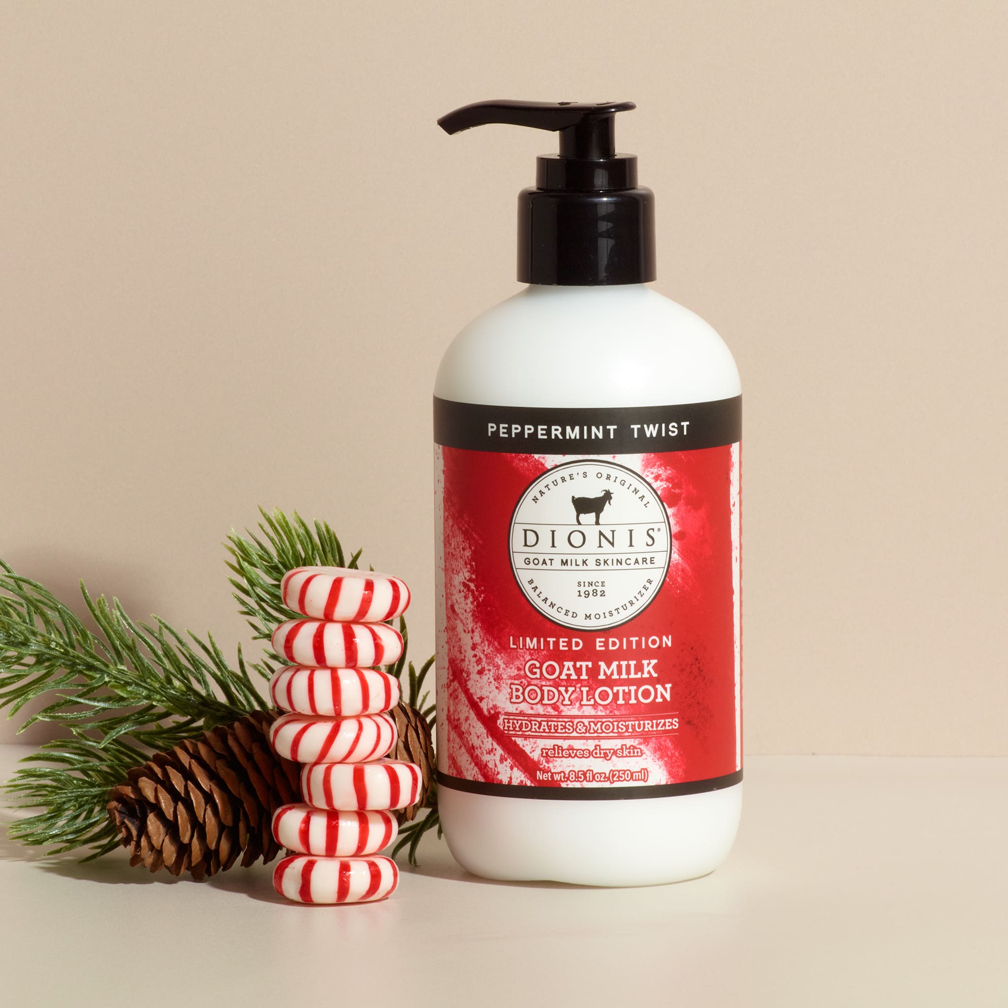Dionis Goat Milk Body Lotion, Peppermint Twist, 8.5 fl oz with black pump and candies.