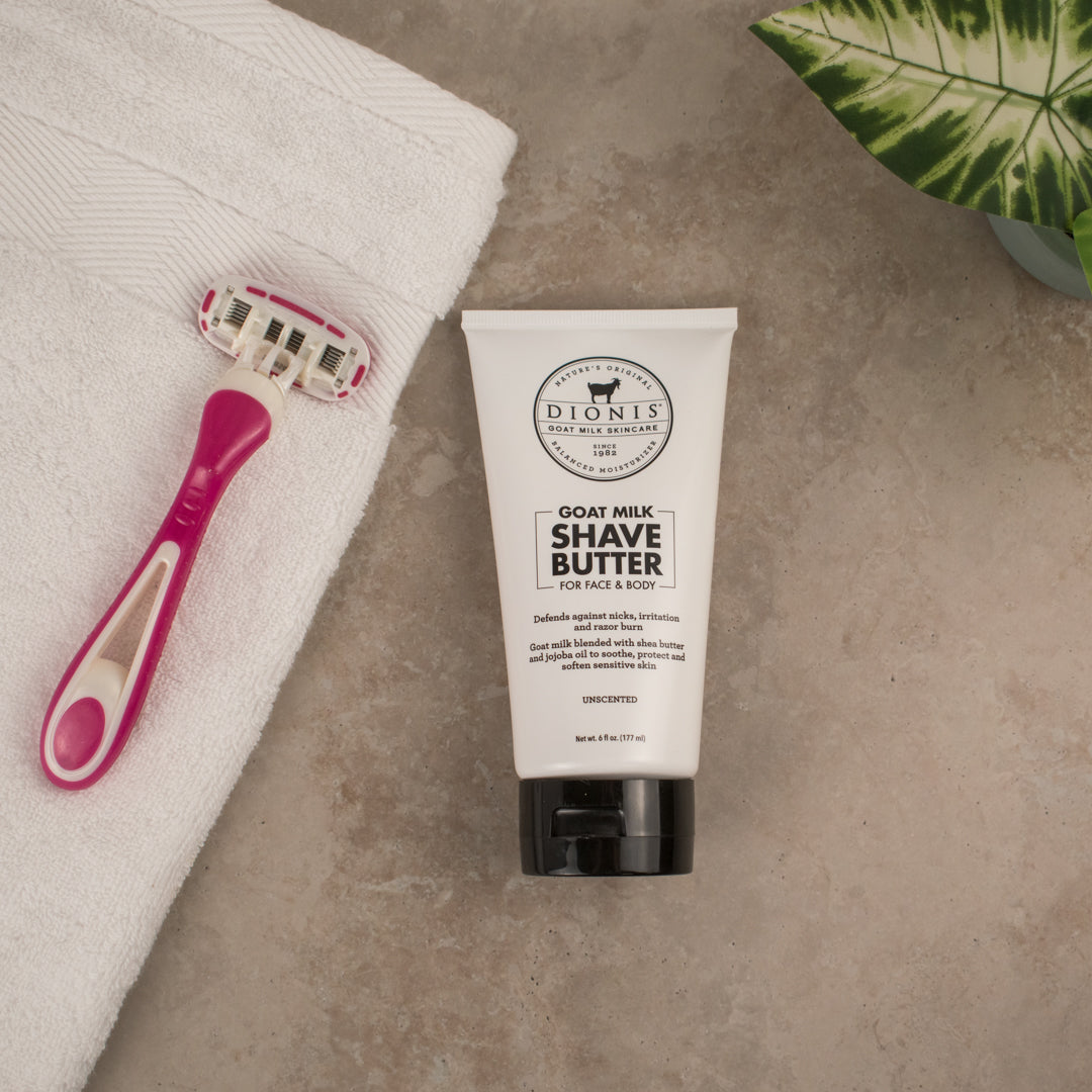 Dionis Goat Milk Shave Butter next to a white towel and pink razor