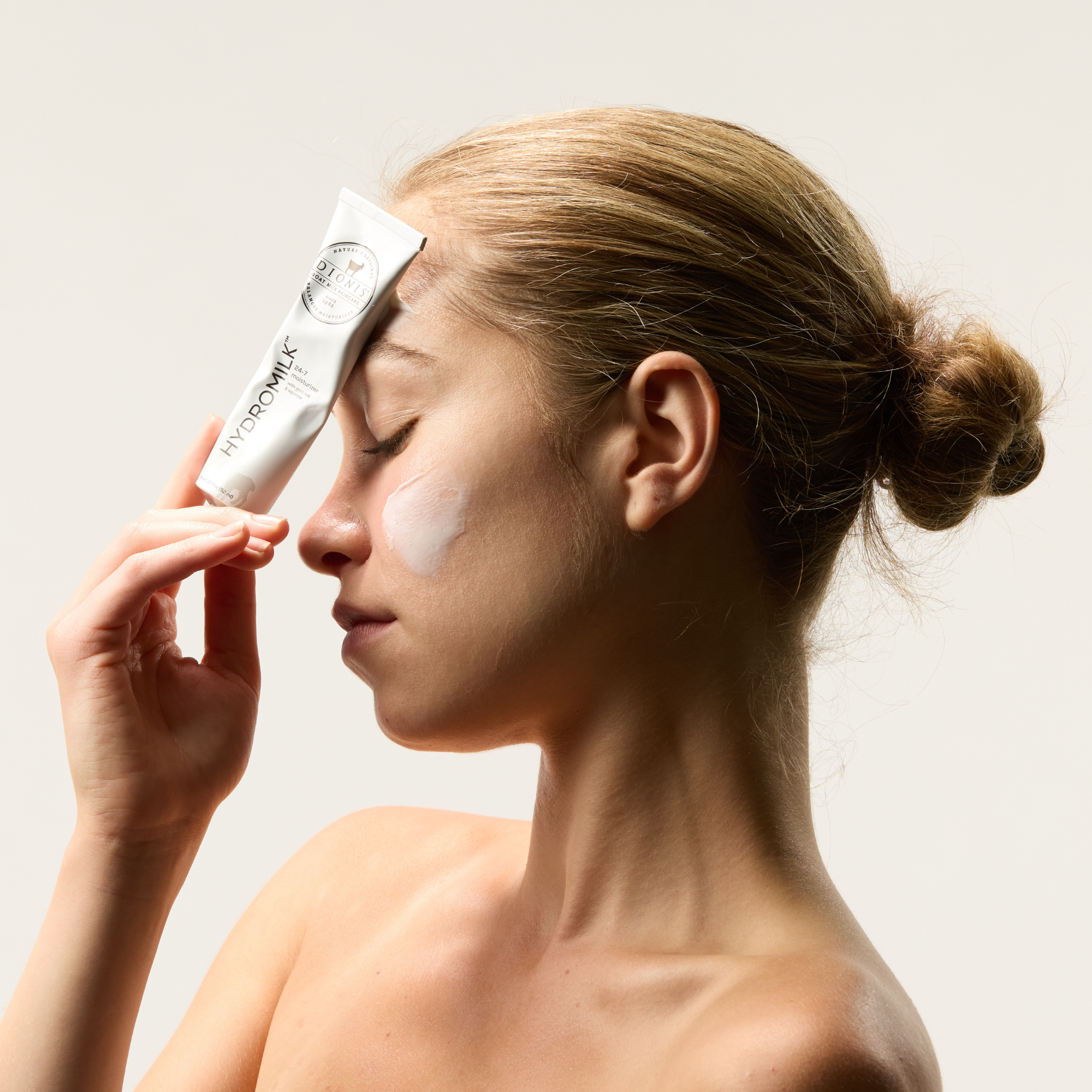 blonde model profile view with hydromilk swatch on her cheek