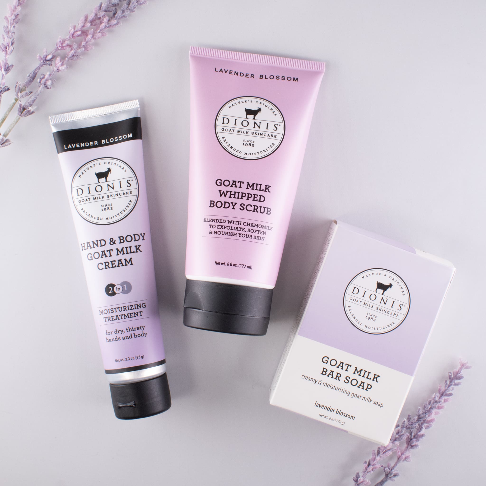 Lavender Blossom hand & body goat milk cream, whipped body scrub, and bar soap together with lavender accessories