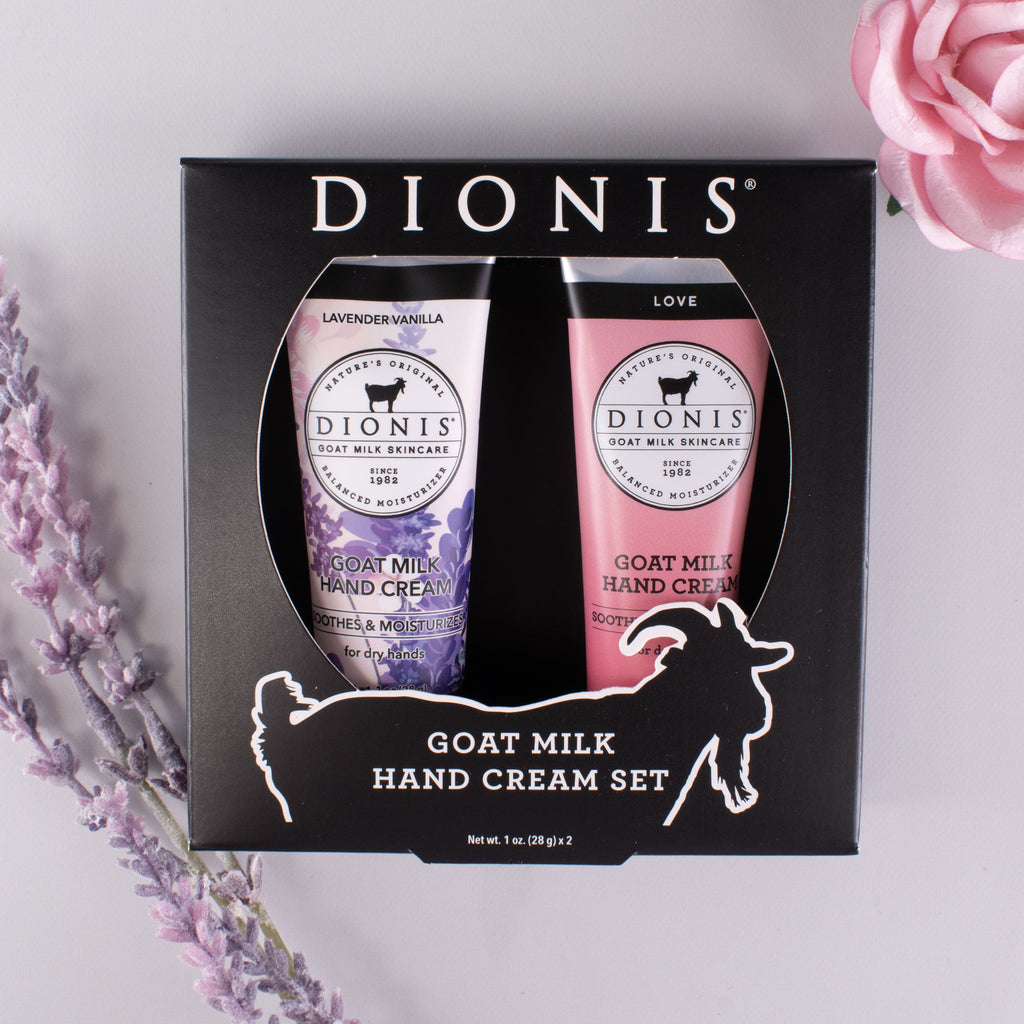 2 1 oz goat milk hand creams in a black box with lavender and rose accessories