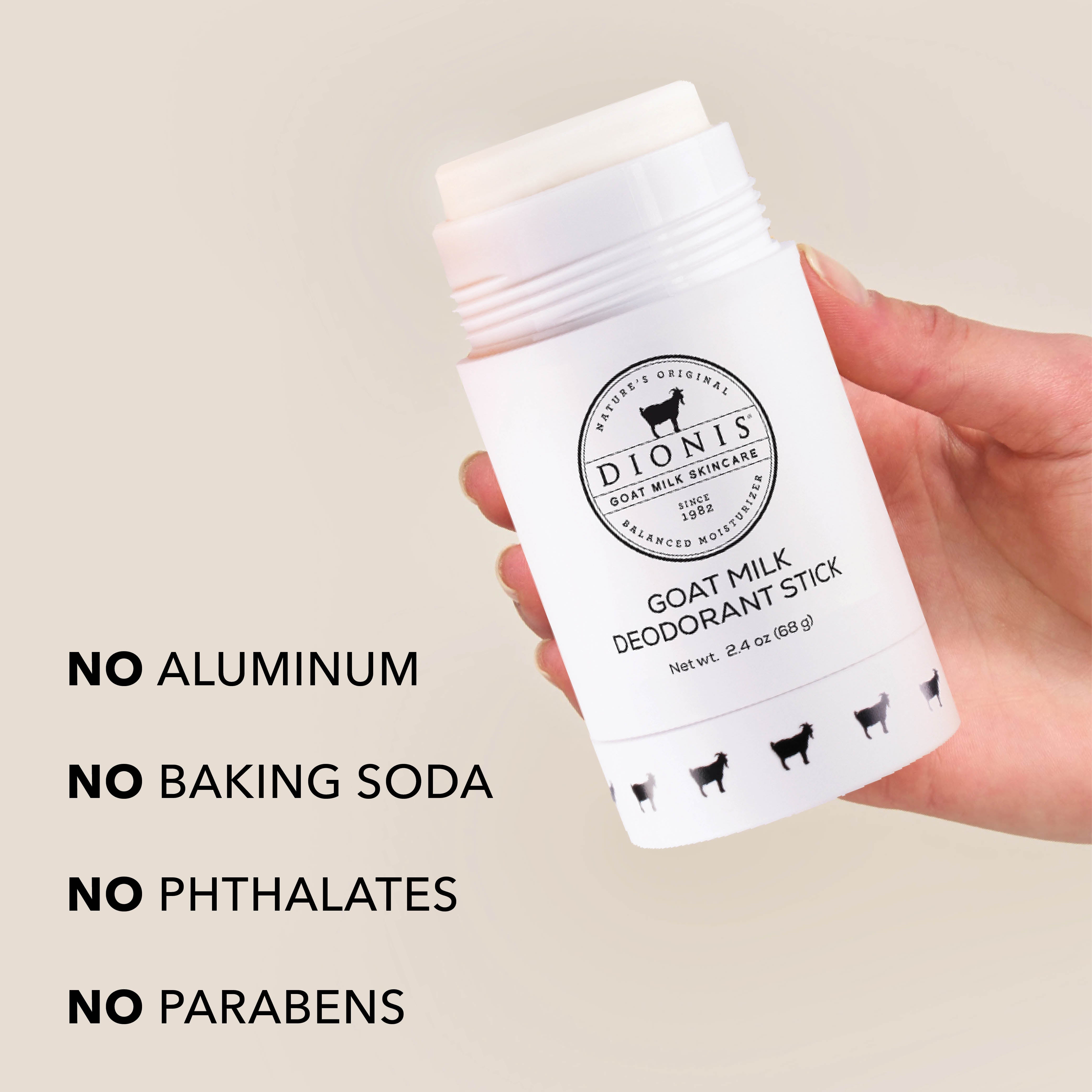 Hand holding original fragrance free Dionis Goat Milk Deodorant Stick. Text on the image reads "No Aluminum. No Baking Soda. No Phthalates. No Parabens."