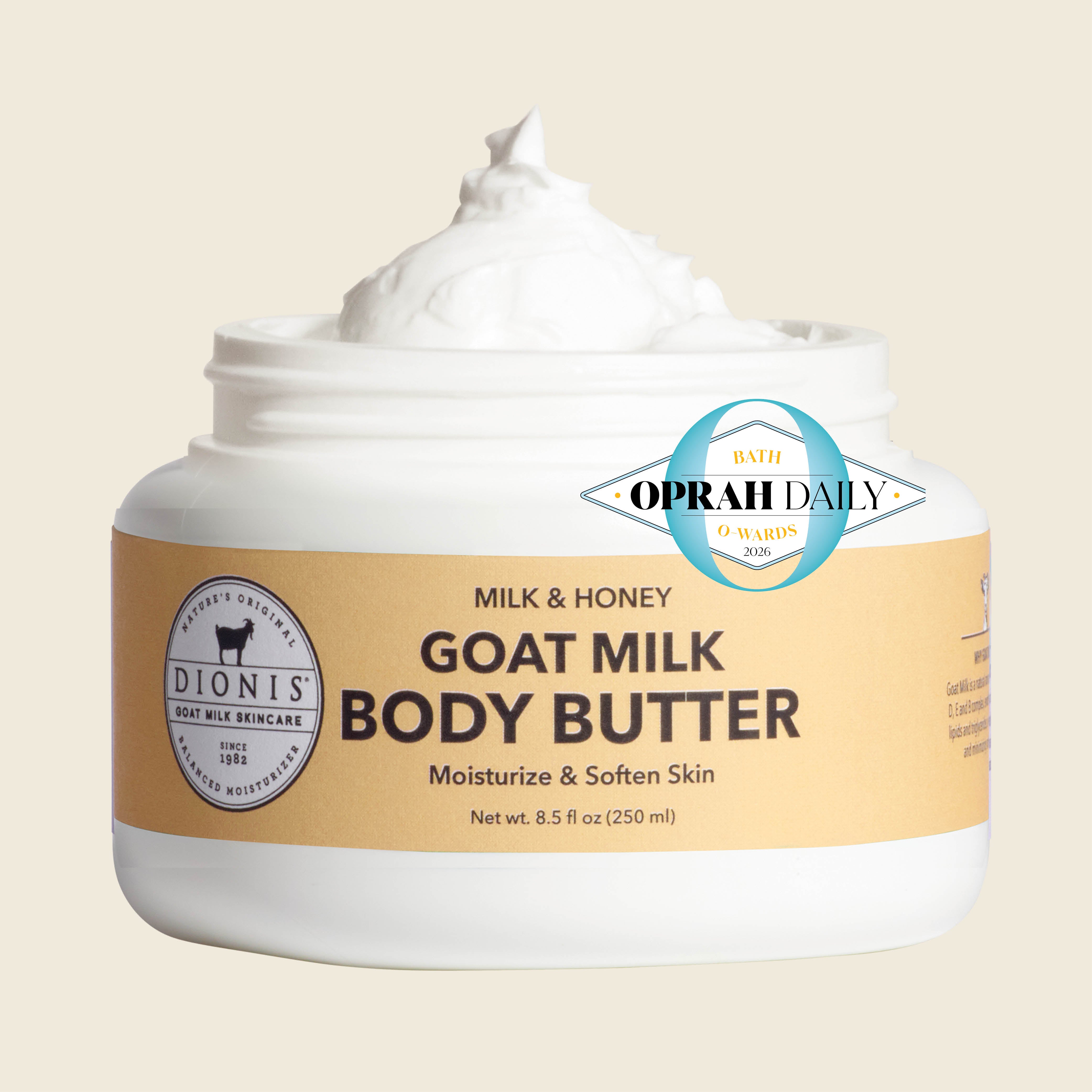 A white jar of Dionis Goat Milk Body Butter with a beige label, shown open with white cream on top, against a light beige background. A blue and white Oprah Daily badge is overlaid on the front.