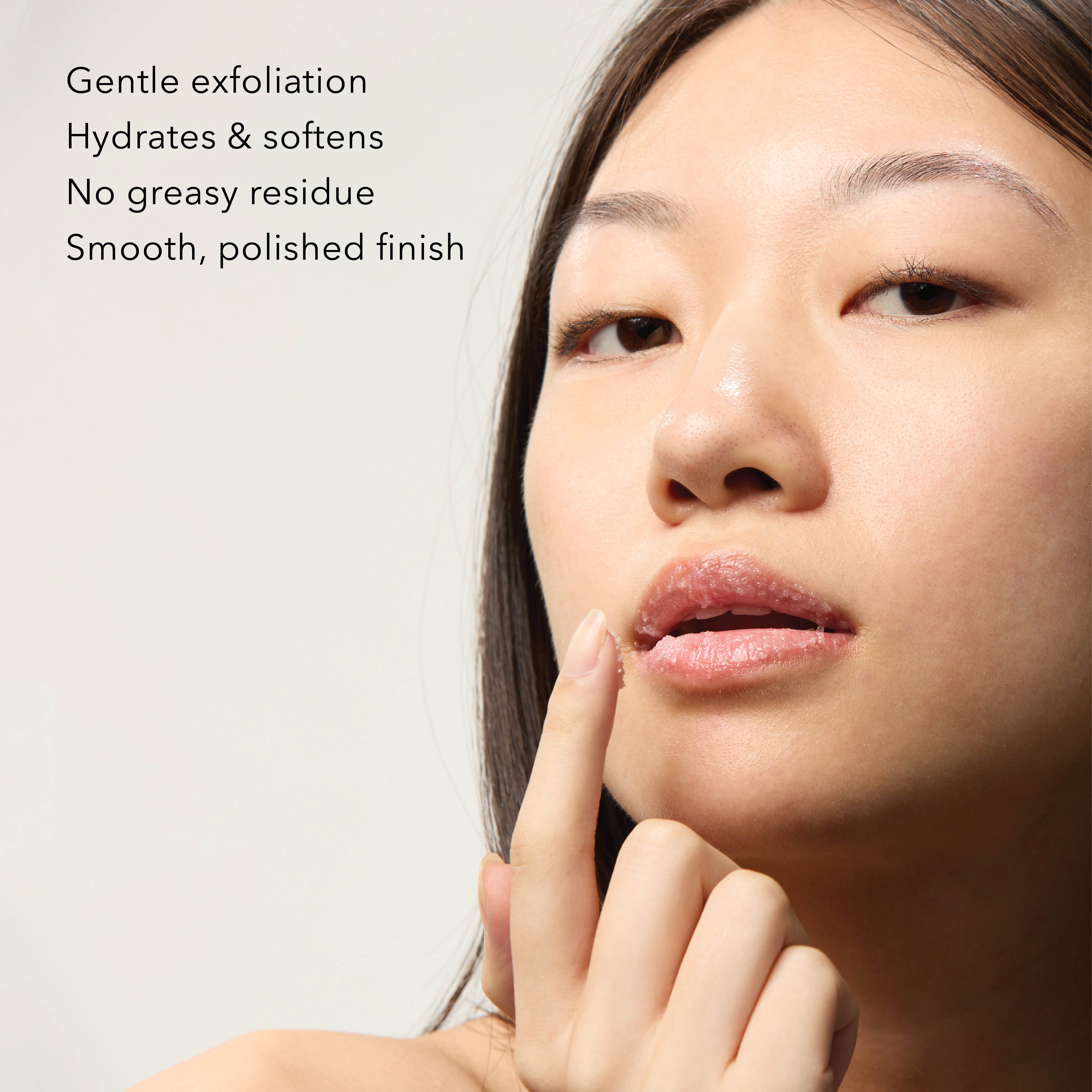 Woman applying Dionis Goat Sugar Lip Scrub to her lips 