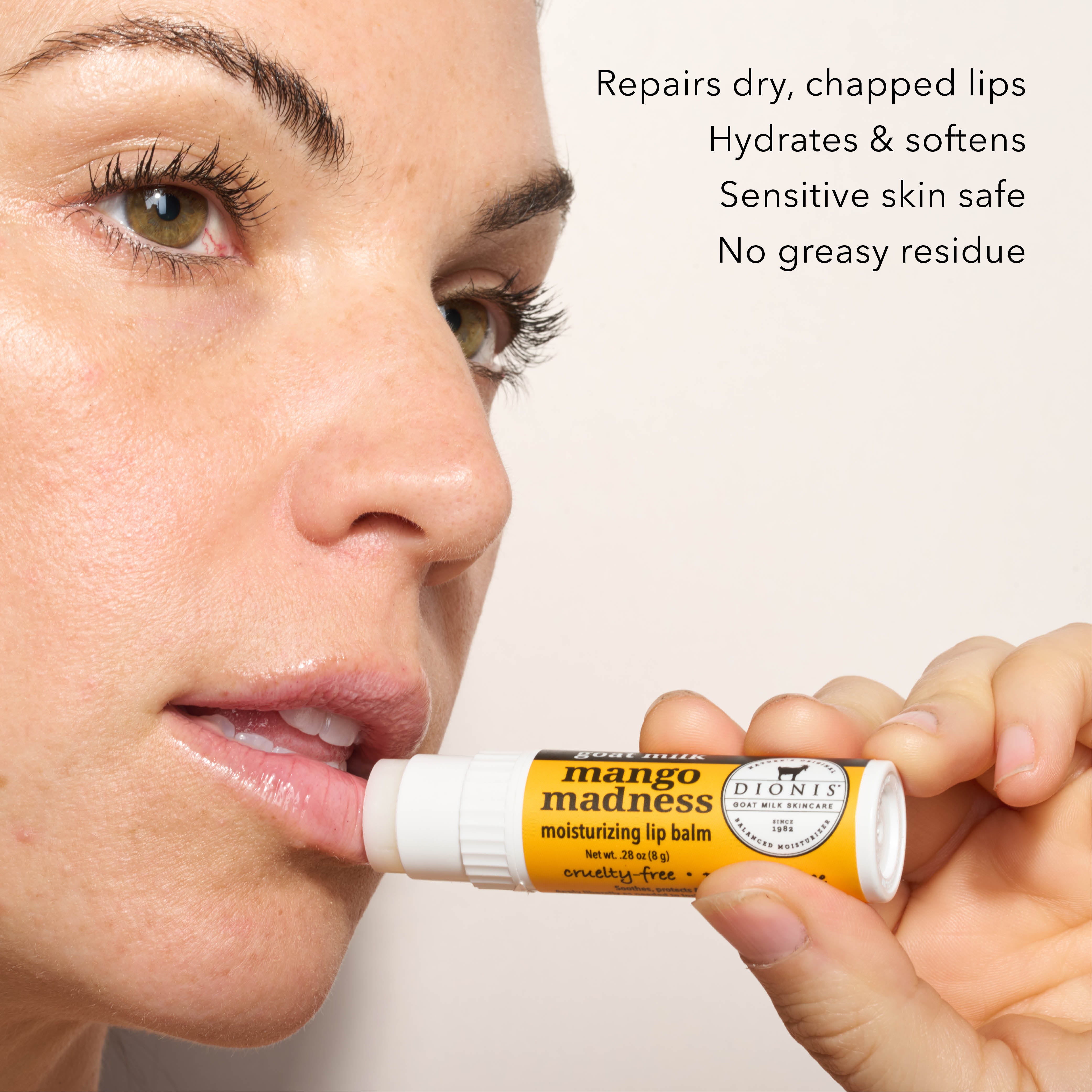 A close up of model applying Dionis Goat Milk Lip Balm, Mango Madness, to lips. 

Benefits: 
- Repairs dry, chapped lips. 
- Hydrates & softens.
- Sensitive skin safe.
- No greasy residue. 
