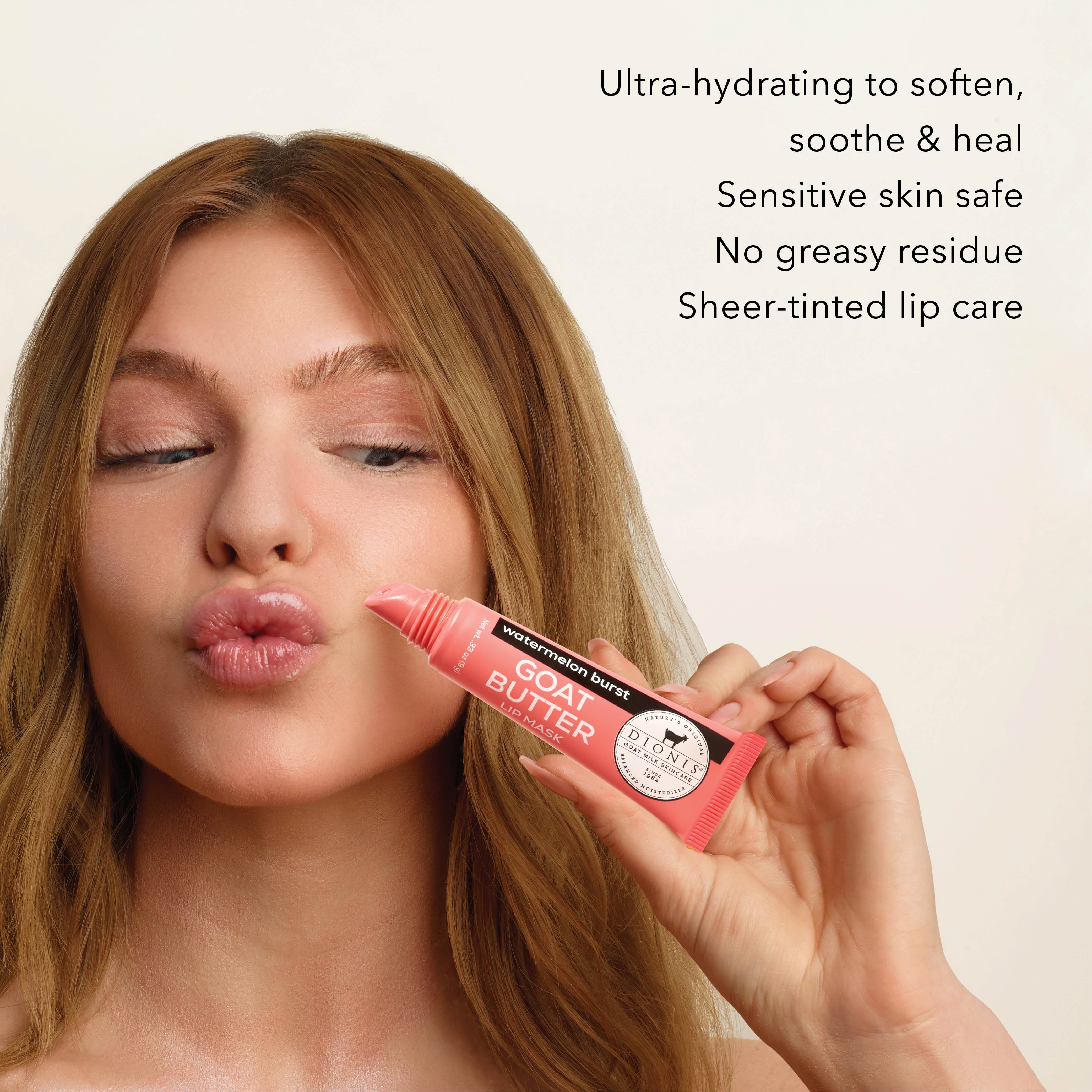 Woman holding Dionis Goat Butter Lip Mask in Watermelon Burst on a beige background