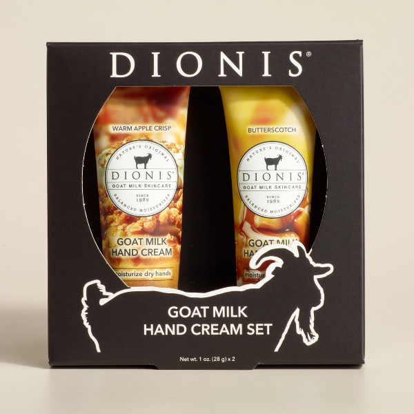 Dionis goat milk hand cream set packaging on a beige background. Featuring Warm Apple Crisp and Butterscotch hand creams.