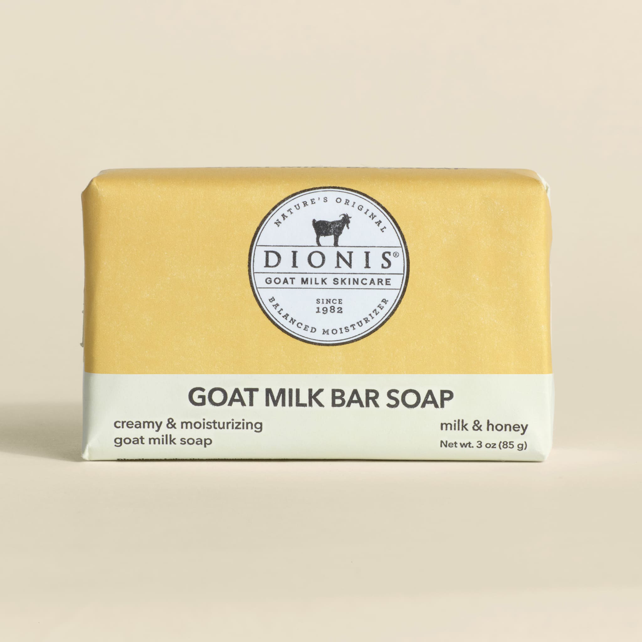 Bar of goat milk soap with Dionis branding on a beige background