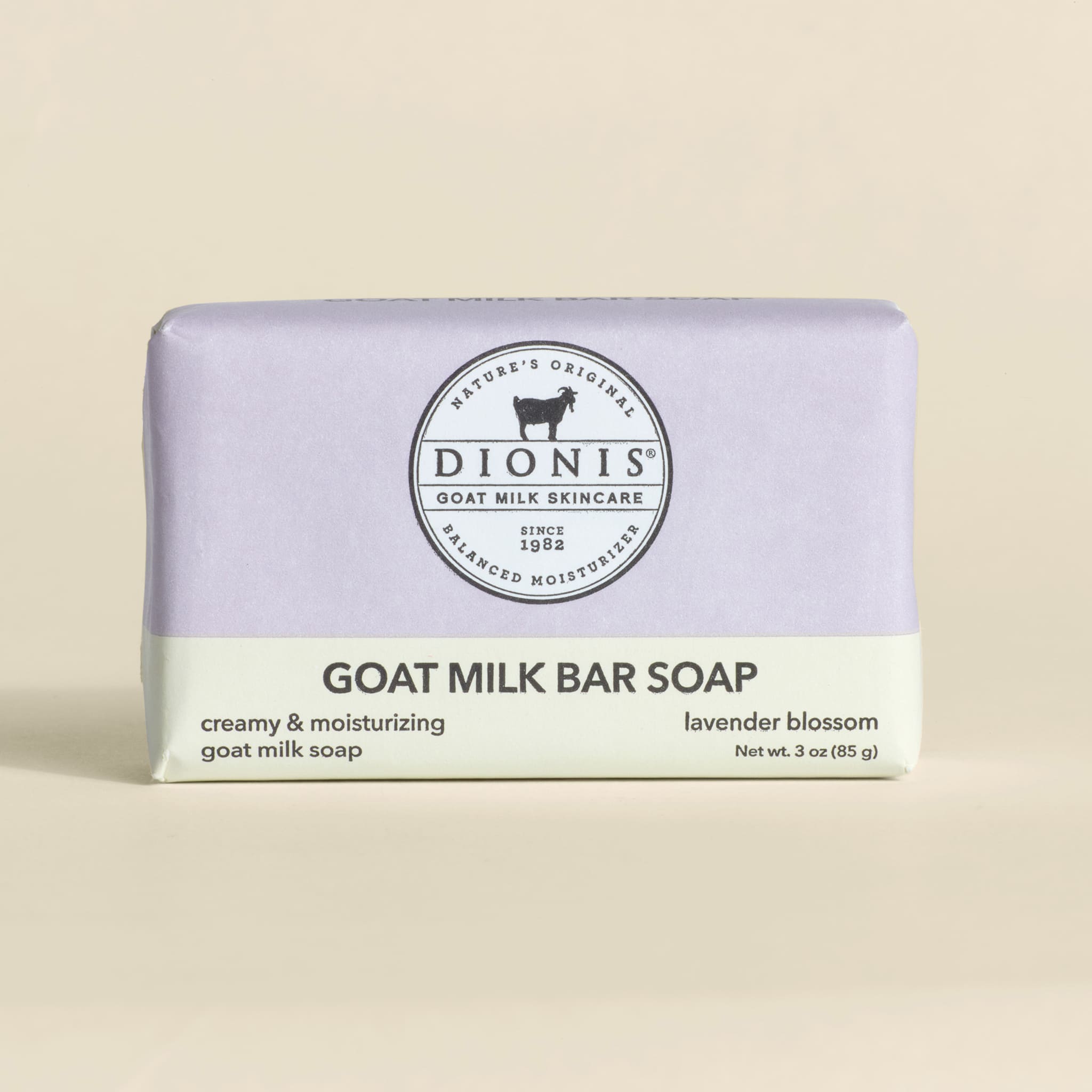 Bar of goat milk soap with 'Dionis' branding on a beige background