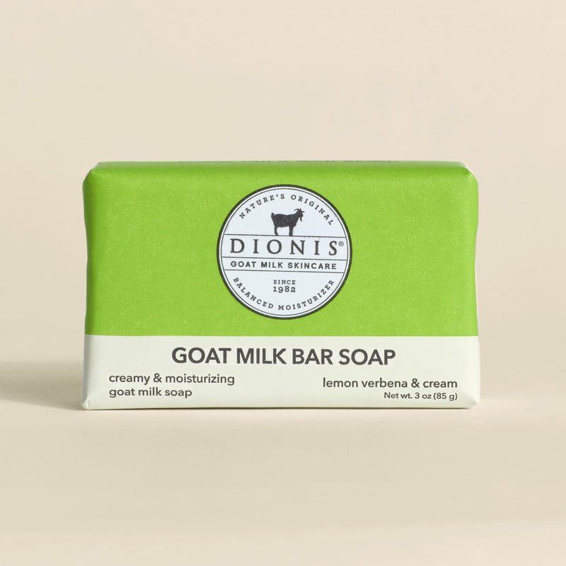 Bar of goat milk soap with green and white packaging on a beige background