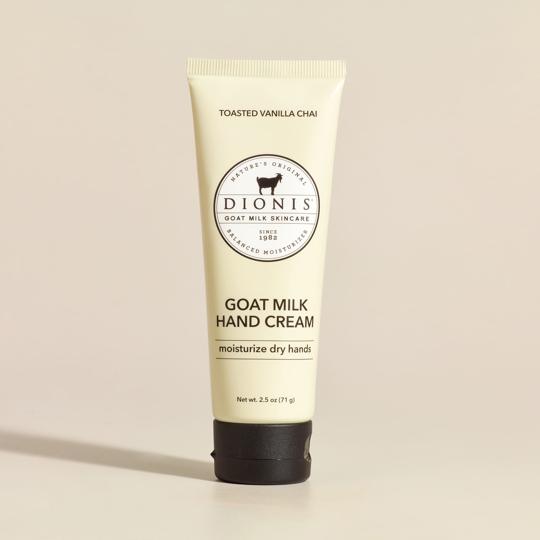 Tube of Dionis Goat Milk Hand Cream on a beige background