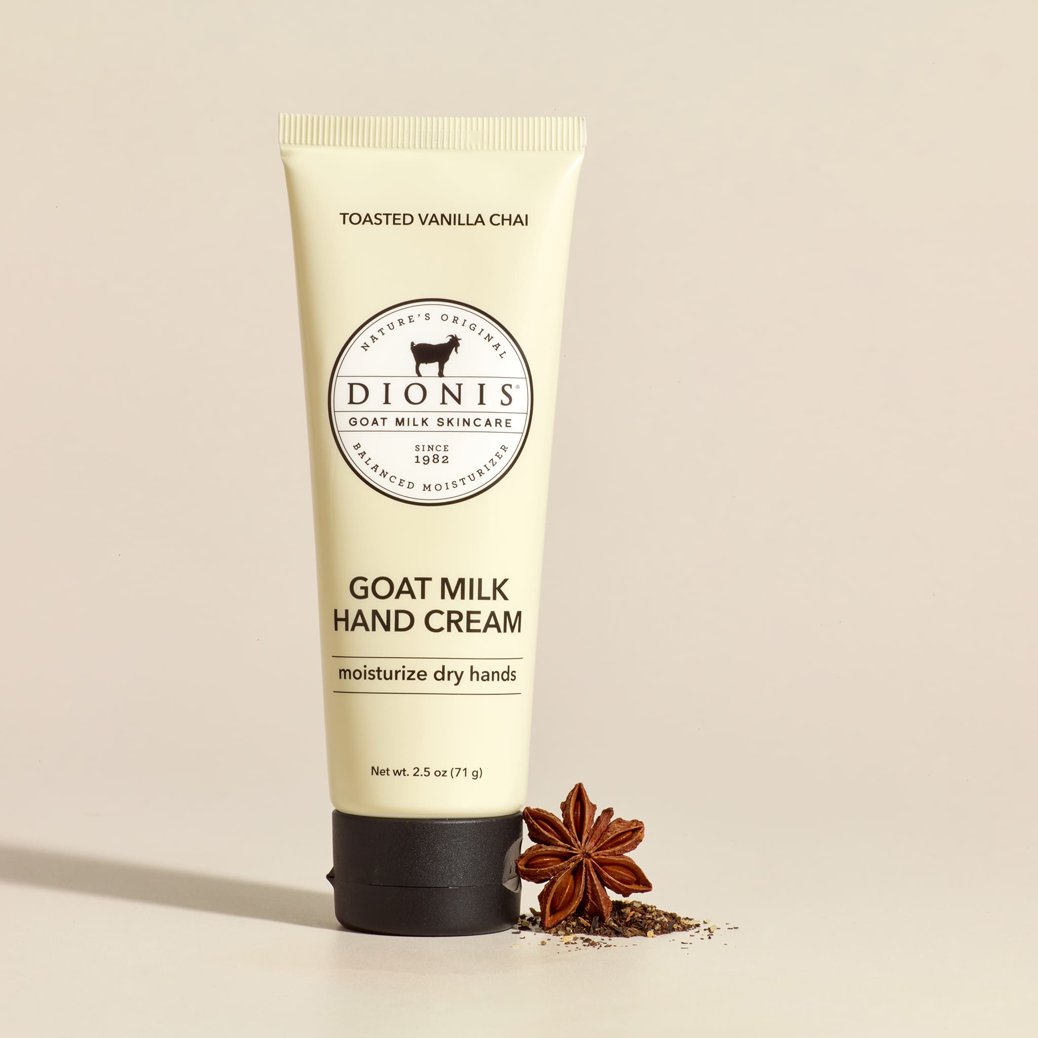 Tube of Dionis Goat Milk Hand Cream on a beige background