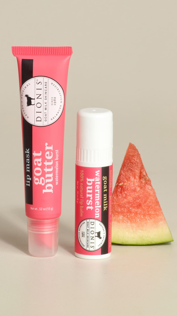 Two Dionis Goat Milk Skincare Watermelon lip products with a watermelon slice on a neutral background