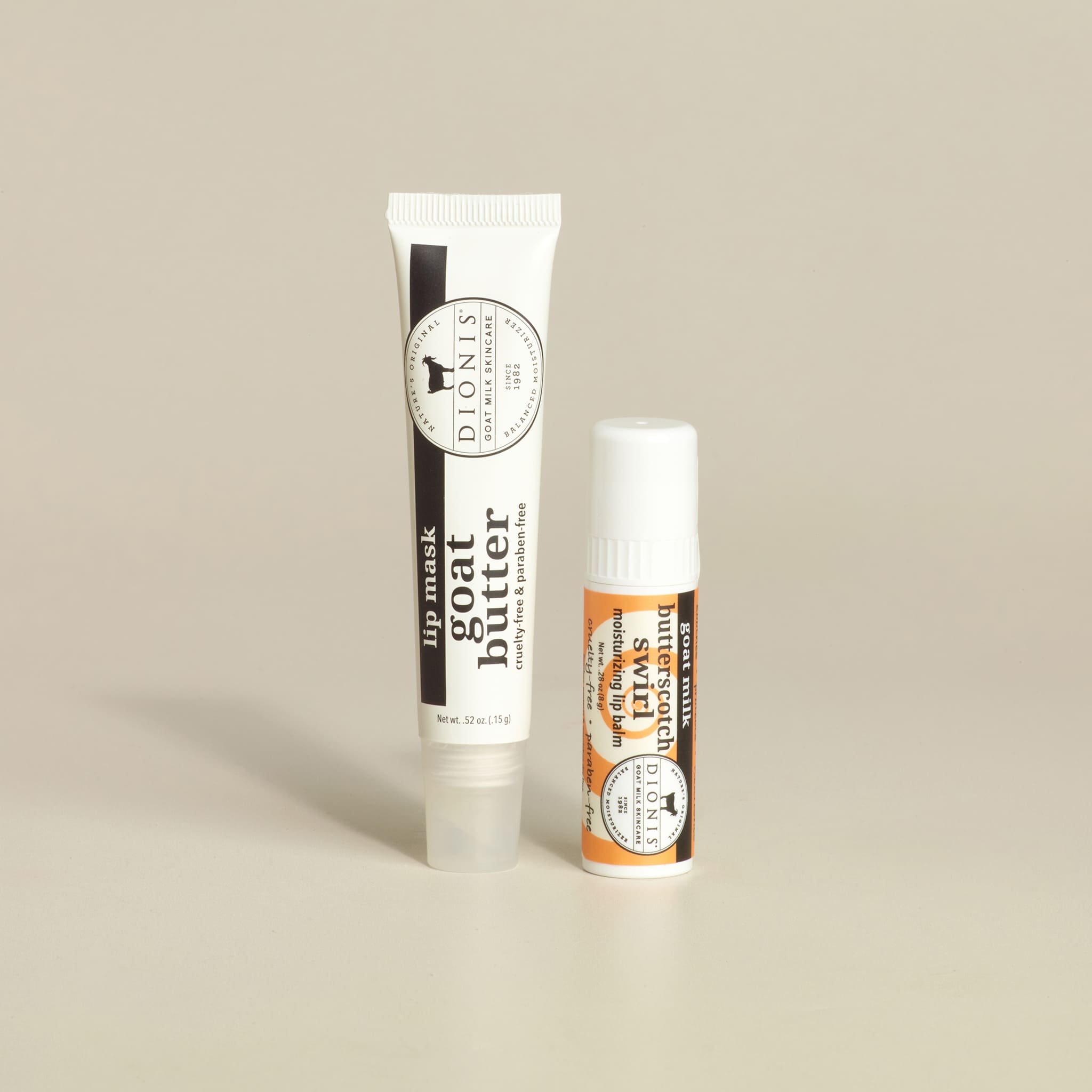 Two lip balm tubes on a beige background