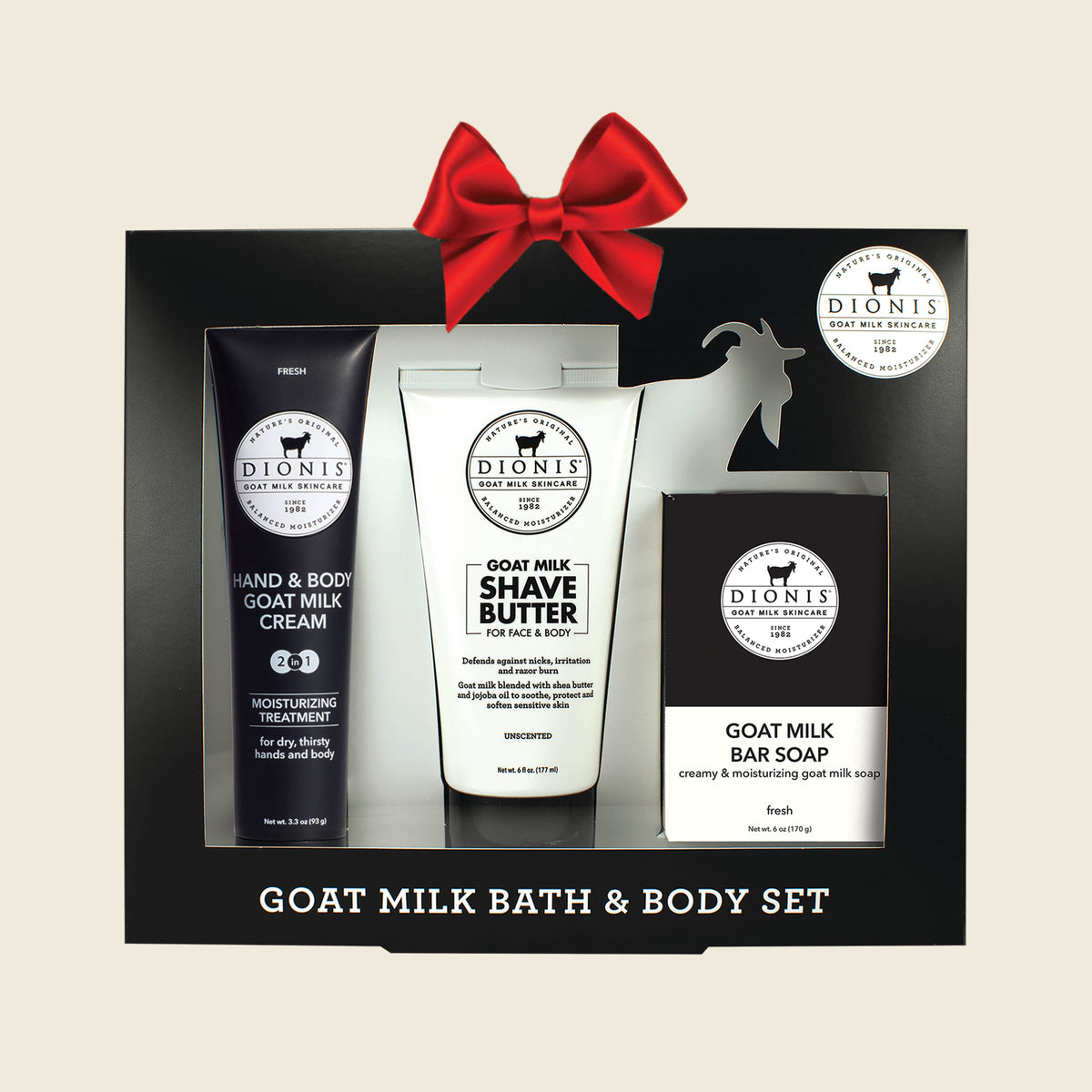 Goat milk bath and body set with hand & body cream, shave butter, and bar soap in a black box on a beige background
