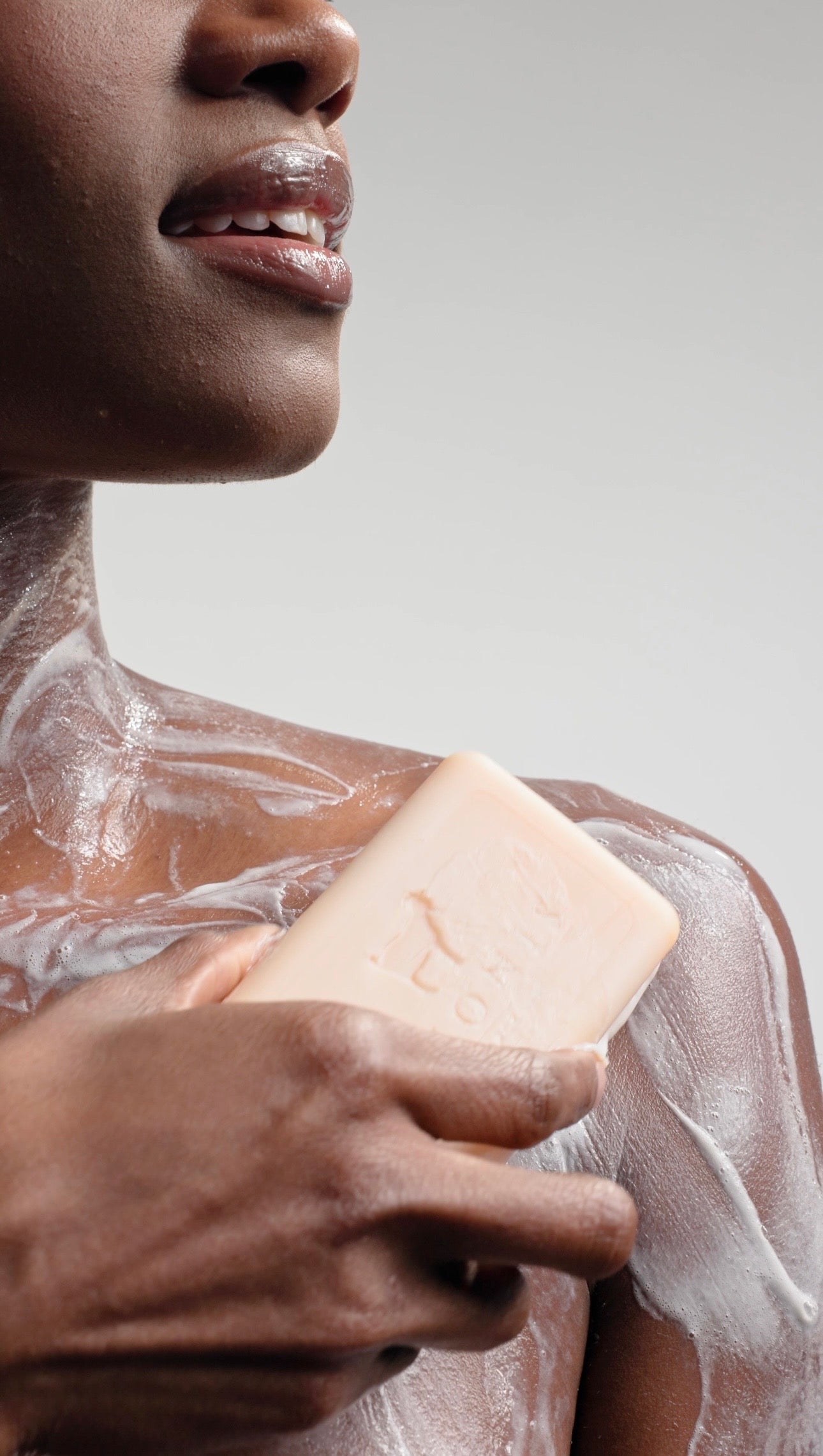 dionis-bar-soap-lather-on-womens-shoulder