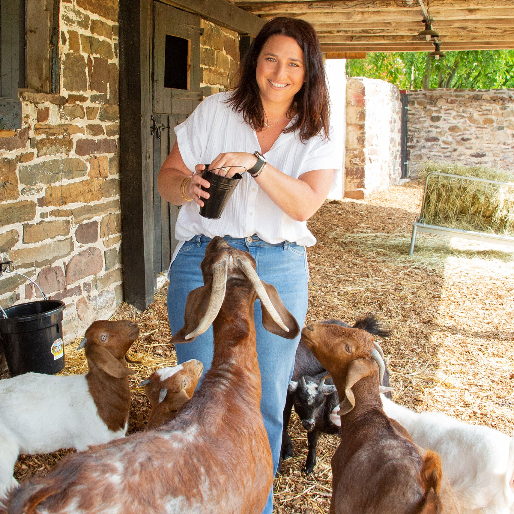 Karen Minsky feeding some of the goats on Dionis Farm.
