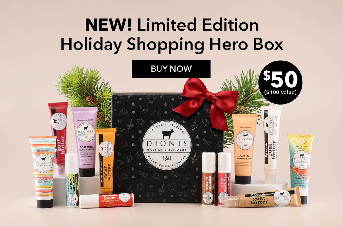 Promotional graphic for the Dionis Limited Edition Holiday Shopping Hero Box, showing a black patterned gift box with a red bow and multiple skincare products arranged around it on a beige background with pine branches. Text reads 'NEW! Limited Edition Holiday Shopping Hero Box,' 'BUY NOW,' and '$50 ($100 value)'.