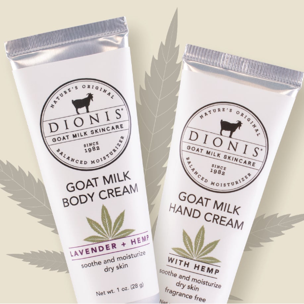 Two white squeeze tubes of Dionis Goat Milk Skincare products on a light beige background with leaf graphics. The left tube is labeled 'GOAT MILK BODY CREAM' with 'LAVENDER + HEMP', and the right tube is labeled 'GOAT MILK HAND CREAM' with 'WITH HEMP'.