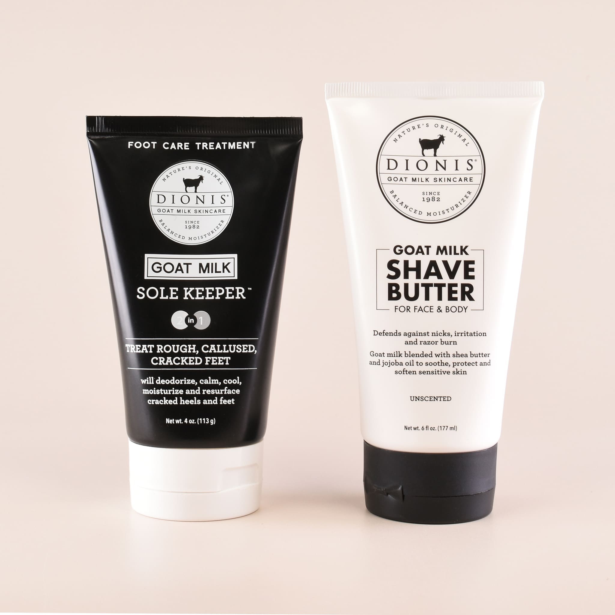 Two Dionis Goat Milk skincare products on a light beige background: a black tube of Sole Keeper foot care treatment and a white tube of Shave Butter for face and body.