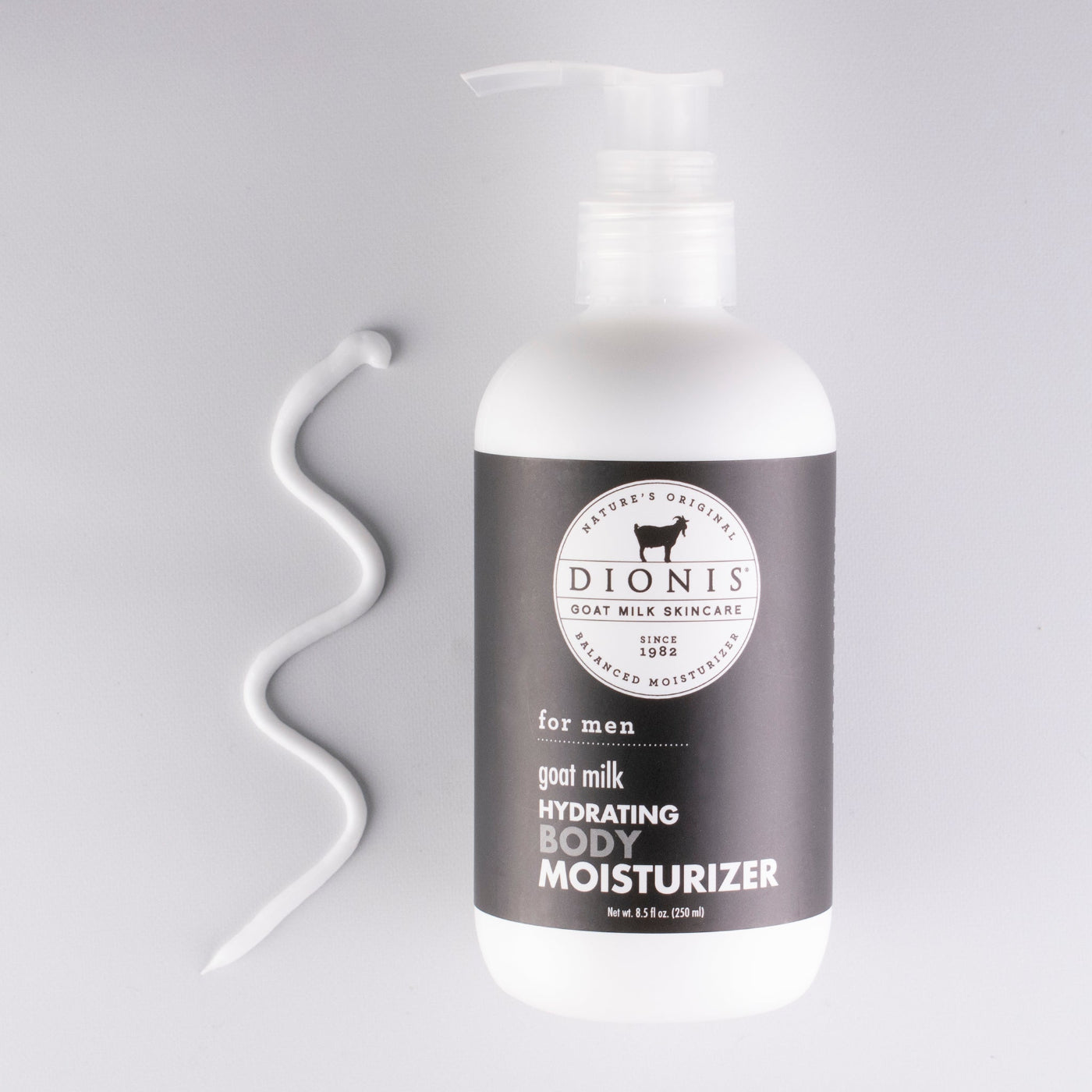 Bottle of Dionis goat milk body moisturizer for men on a light gray background