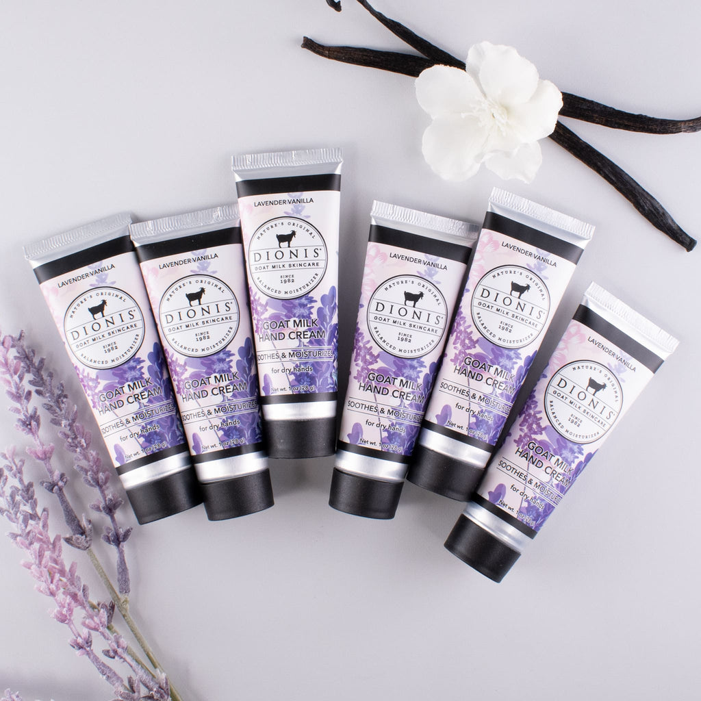 Group of 6 - 1 oz Lavender Vanilla hand creams lined up, with lavender and vanilla bean accessories