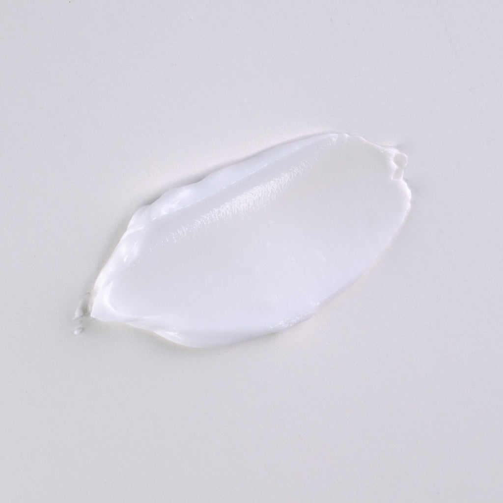 Swatch of goat milk hand cream on flat surface