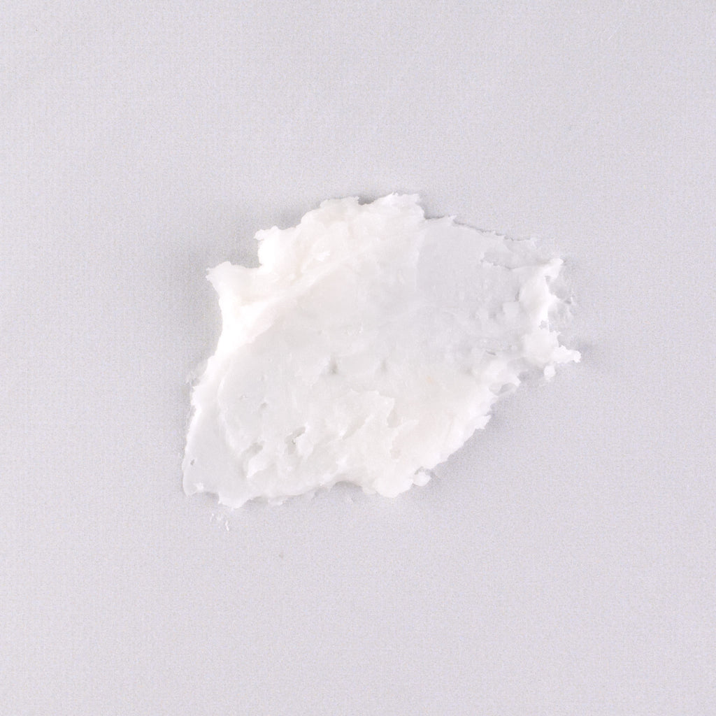 Swatch of goat milk lip balm on flat surface